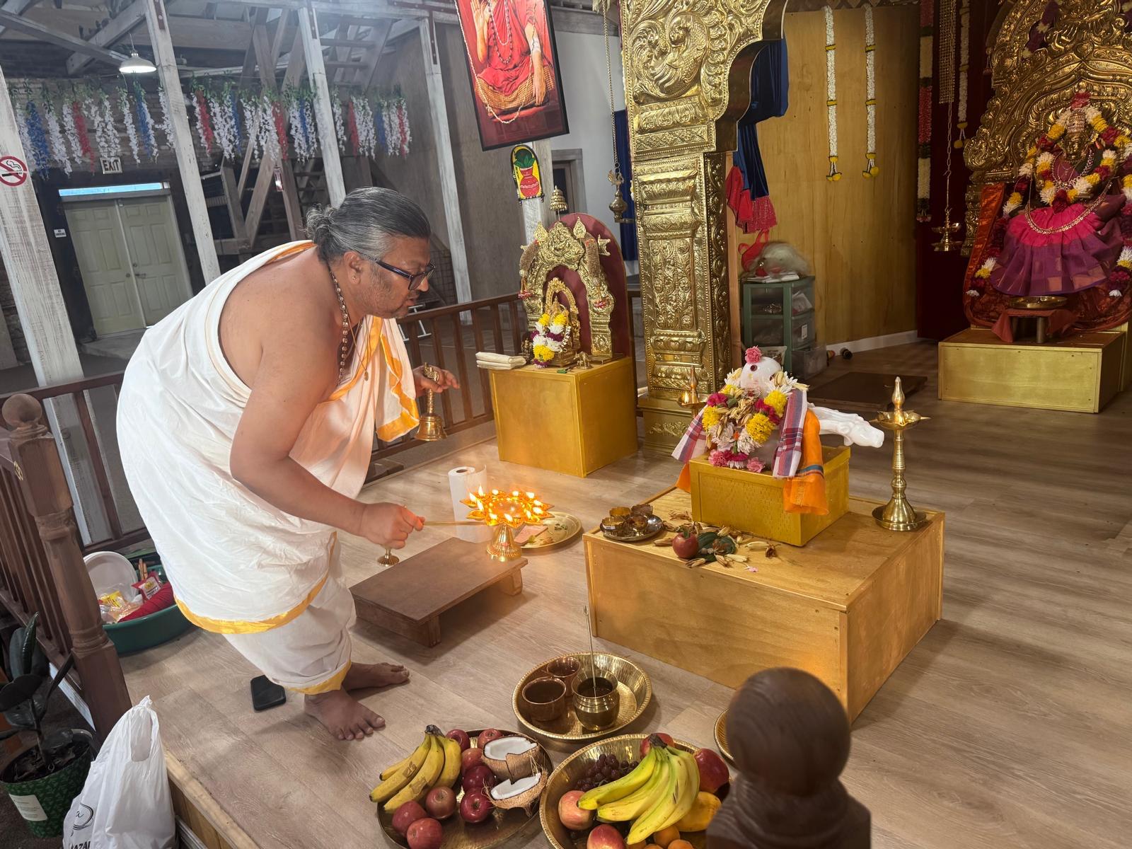 Priest offering aarti at the shrine