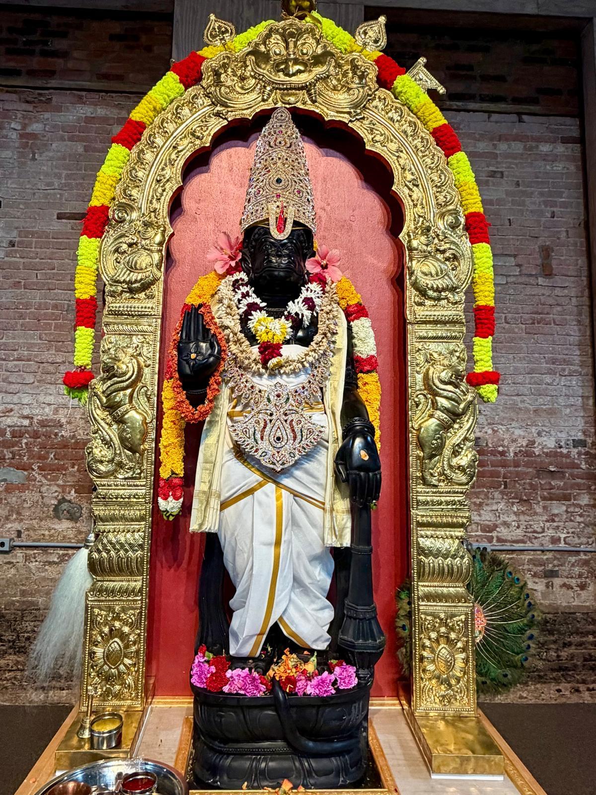 Deity decorated with a floral arch