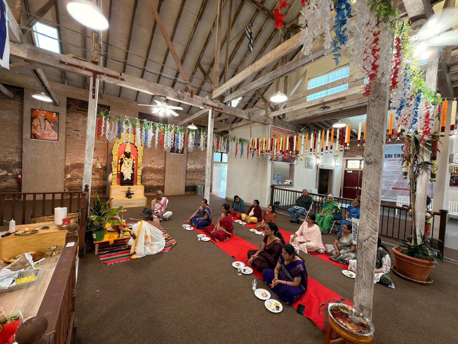 Devotees performing puja together in the main hall