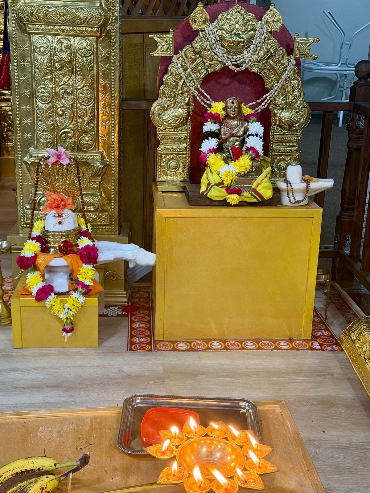 Shrine decorated with flowers and lit lamps